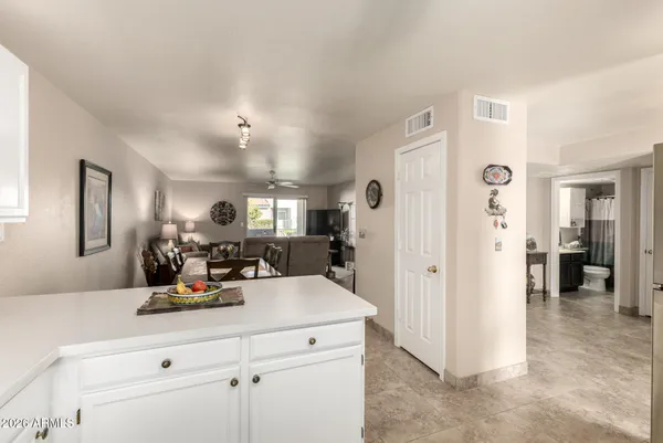 a view of a kitchen with a refrigerator and a view of living room