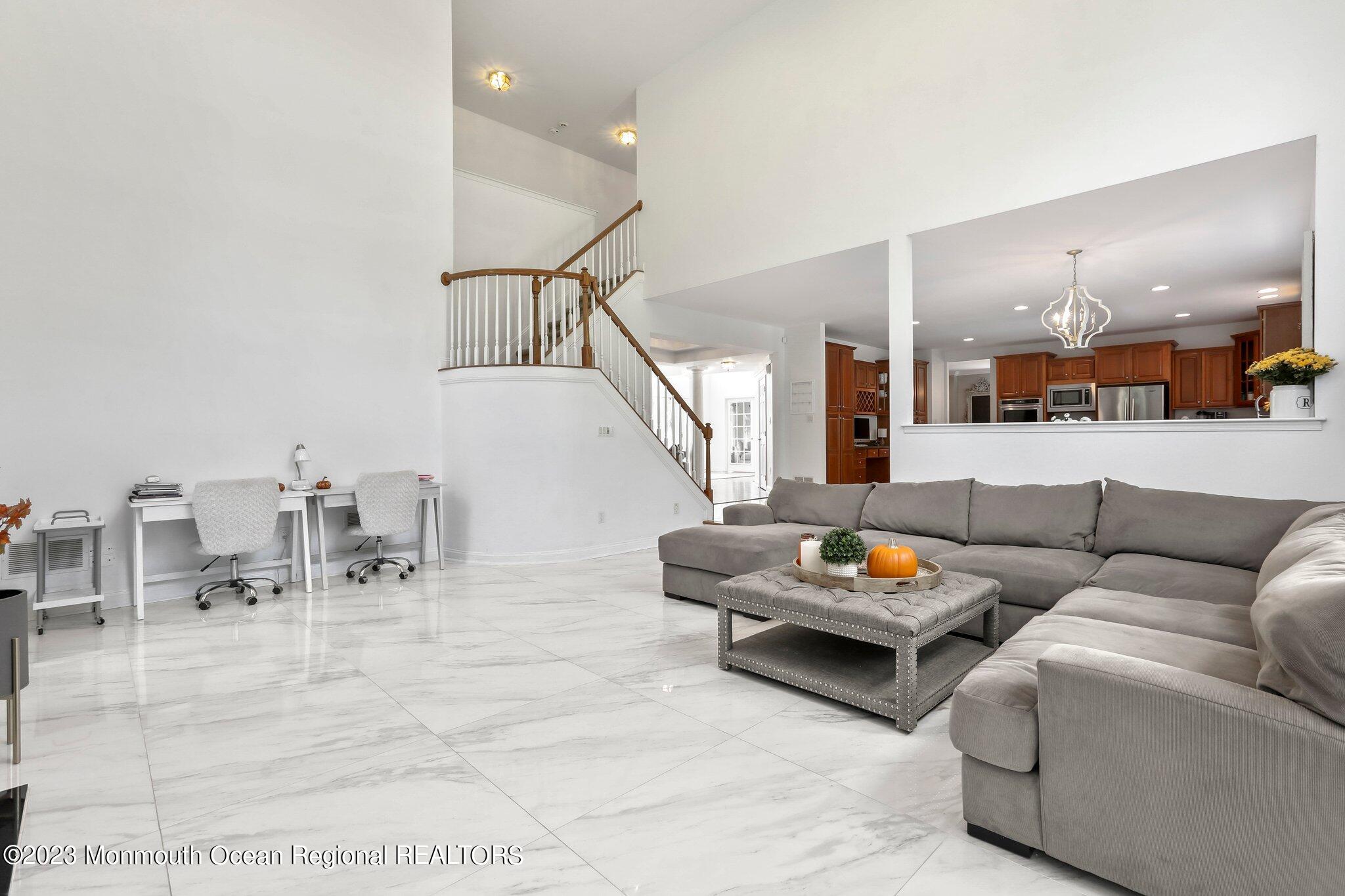 2 Wilson Boulevard Jackson, NJ 08527 - Photo 20 of 41 a living room with furniture and a dining table with kitchen view