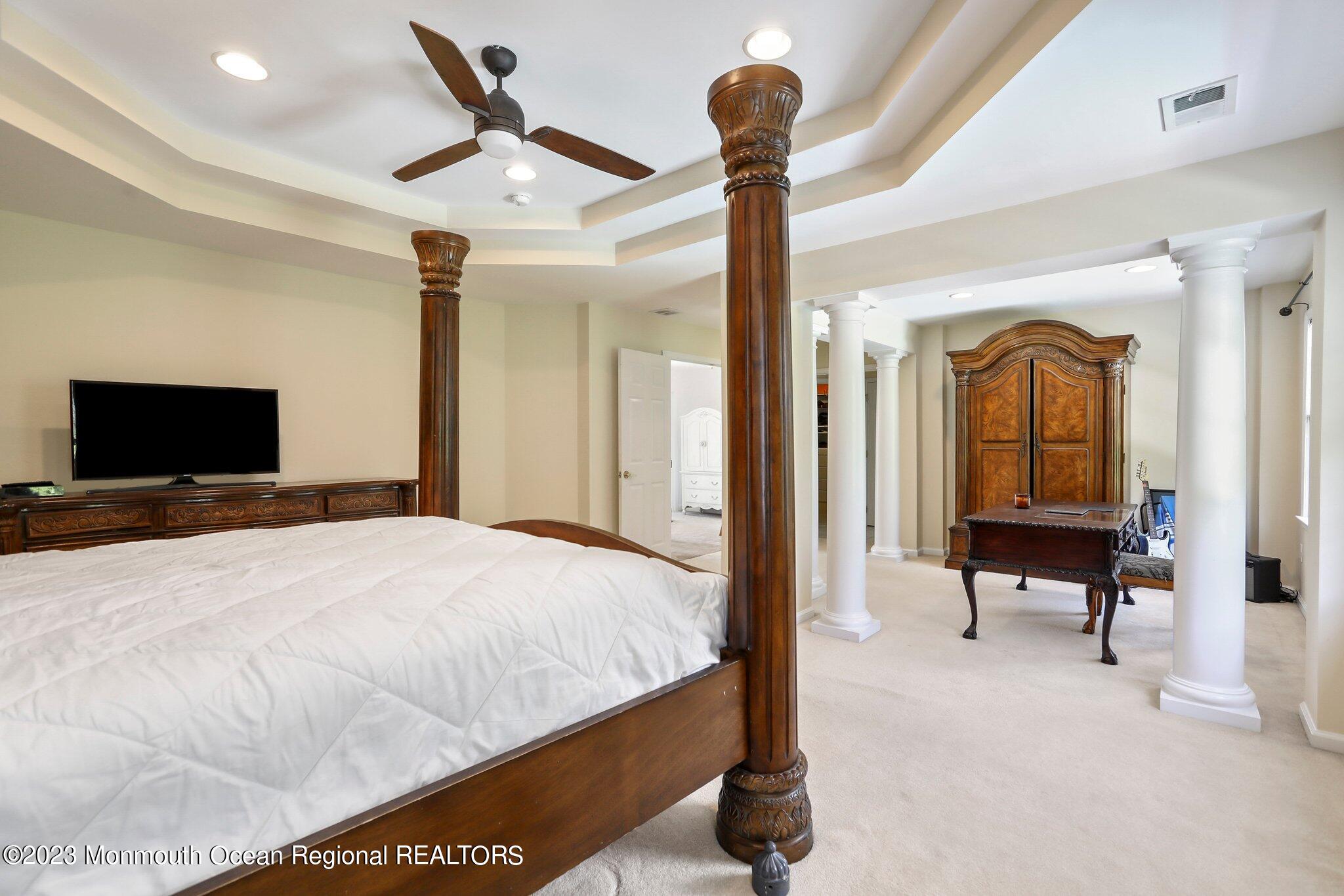 2 Wilson Boulevard Jackson, NJ 08527 - Photo 24 of 41 a bedroom with a bed and a chandelier