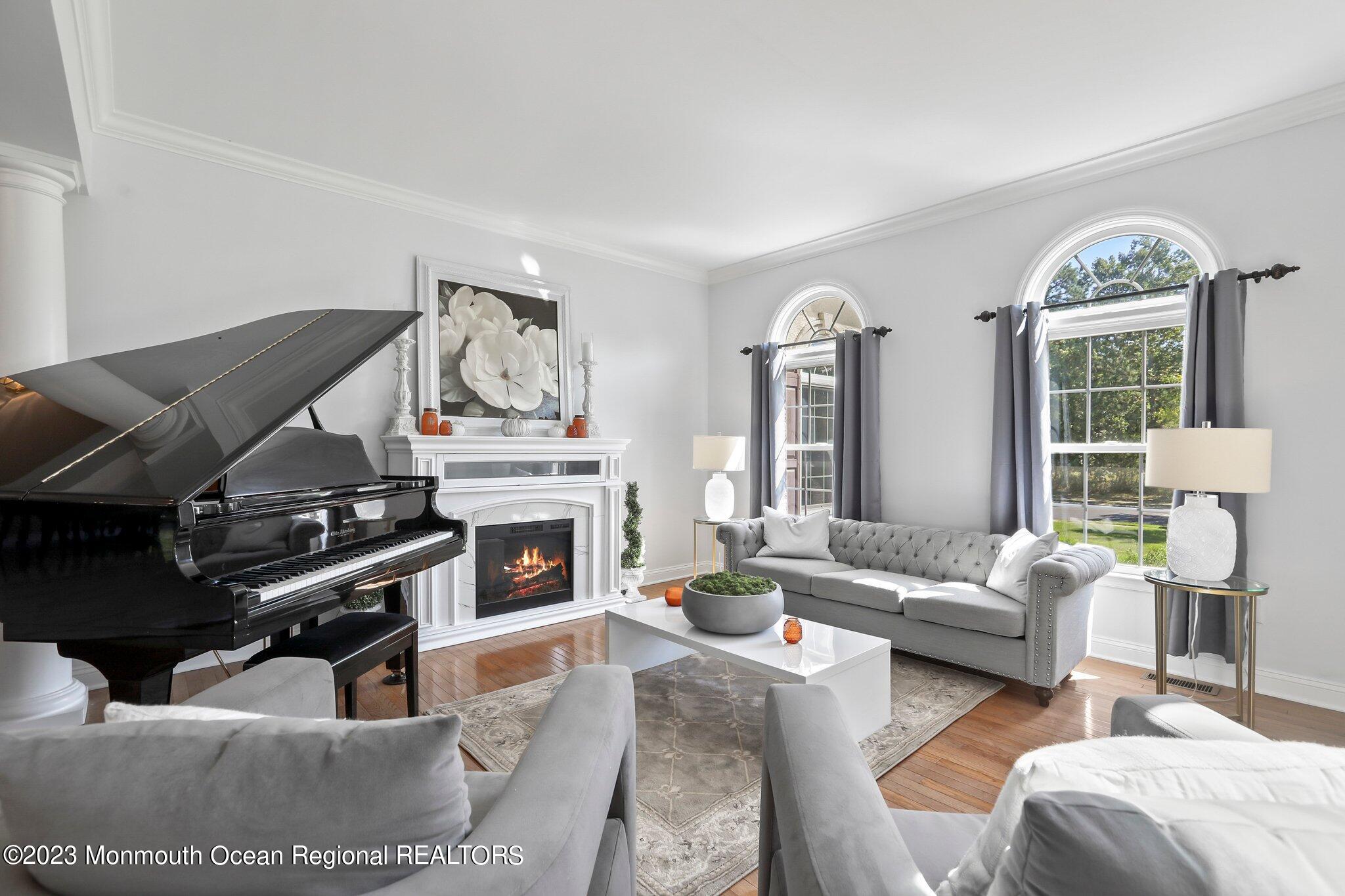 2 Wilson Boulevard Jackson, NJ 08527 - Photo 7 of 41 a living room with furniture a fireplace and a floor to ceiling window