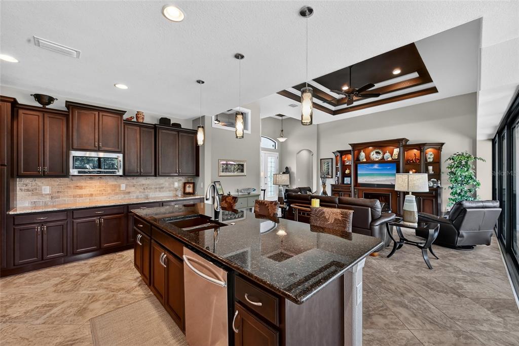 8 Windward Road Placida, FL 33946 - Photo 13 of 47 a kitchen with kitchen island granite countertop a sink counter top space appliances and a window