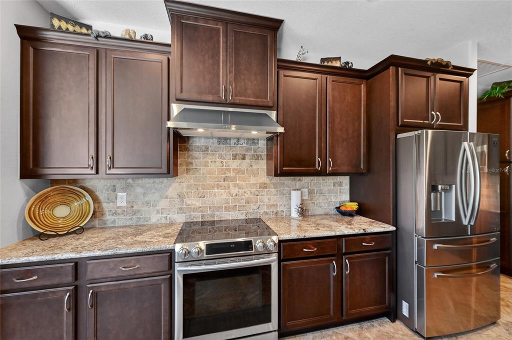 8 Windward Road Placida, FL 33946 - Photo 16 of 47 a kitchen with stainless steel appliances granite countertop a refrigerator stove and sink