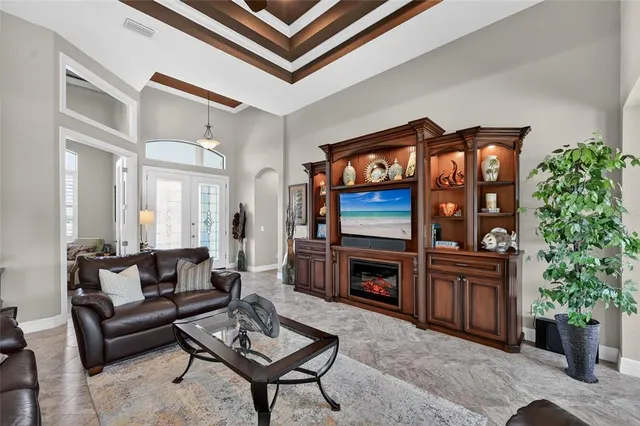 a living room with furniture a fireplace and a potted plant