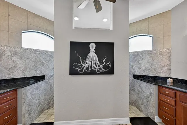 a kitchen with stainless steel appliances granite countertop a refrigerator and a stove with wooden floor