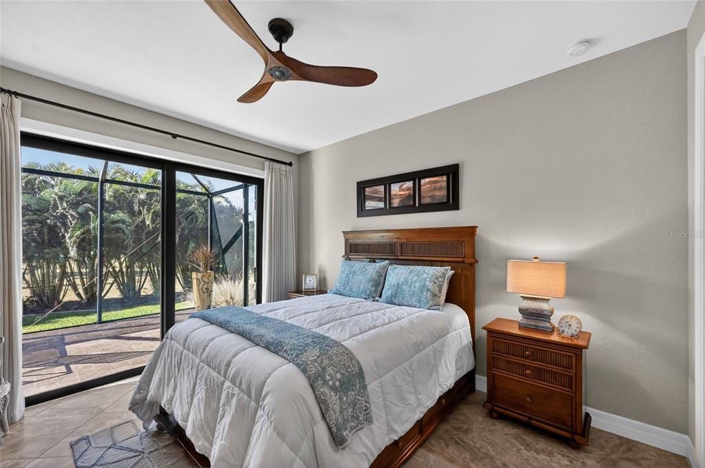 8 Windward Road Placida, FL 33946 - Photo 31 of 47 a bedroom with a bed and large window