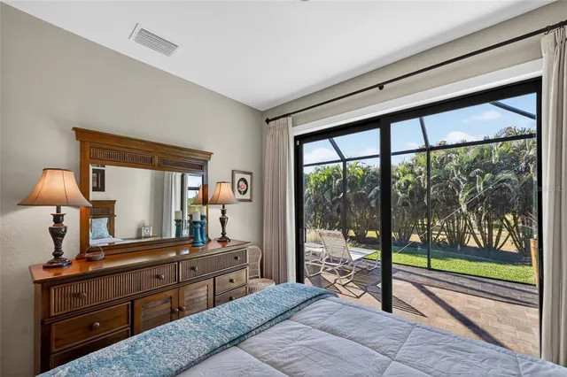 a bathroom with a granite countertop sink mirror vanity and toilet
