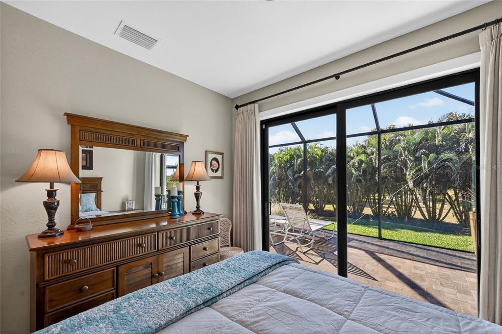 8 Windward Road Placida, FL 33946 - Photo 32 of 47 a bedroom with a bed and a large window with balcony view