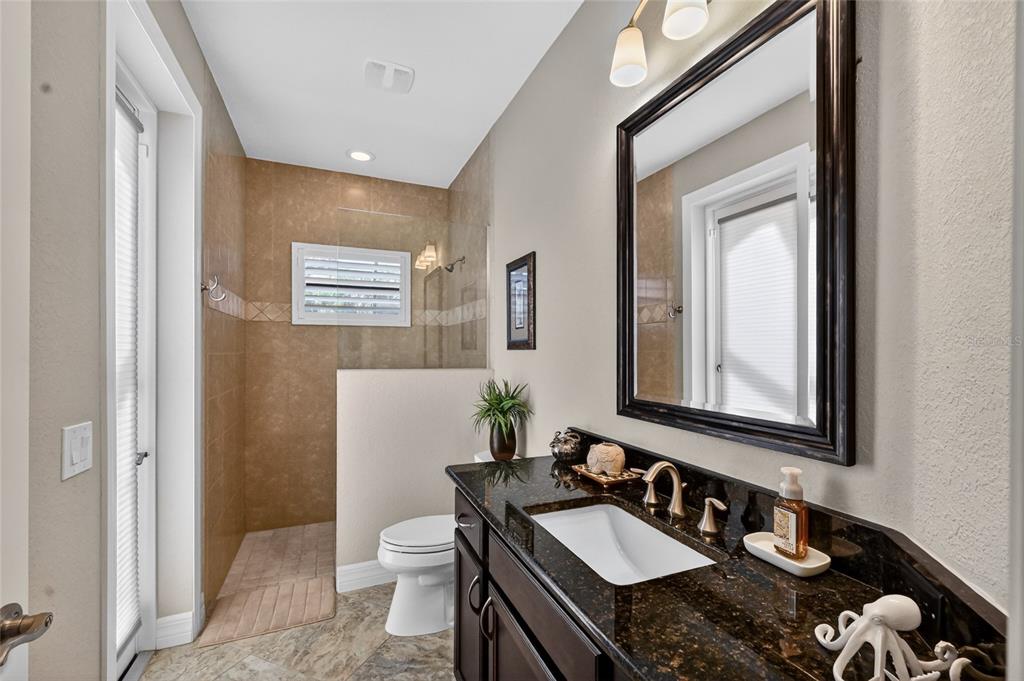 8 Windward Road Placida, FL 33946 - Photo 33 of 47 a bathroom with a granite countertop sink mirror vanity and toilet