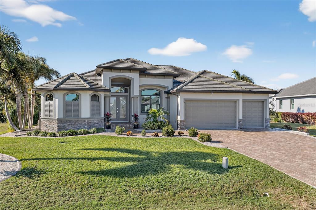 8 Windward Road Placida, FL 33946 - Photo 43 of 47 a front view of a house with a yard and garage
