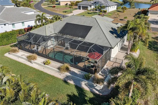 an aerial view of a house with a yard