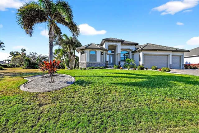 a front view of a house with a garden and trees