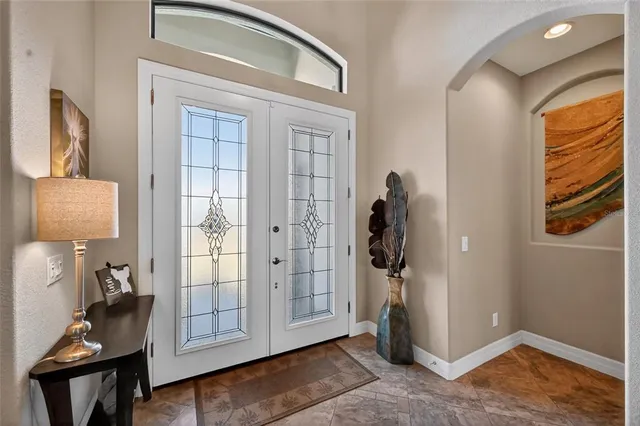 a view of an entryway with wooden floor and mirror