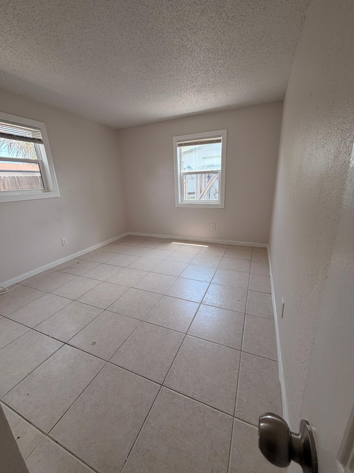 1618 West 26th Court, Unit A Riviera Beach, FL 33404 - Photo 11 of 15 a view of an empty room with a window