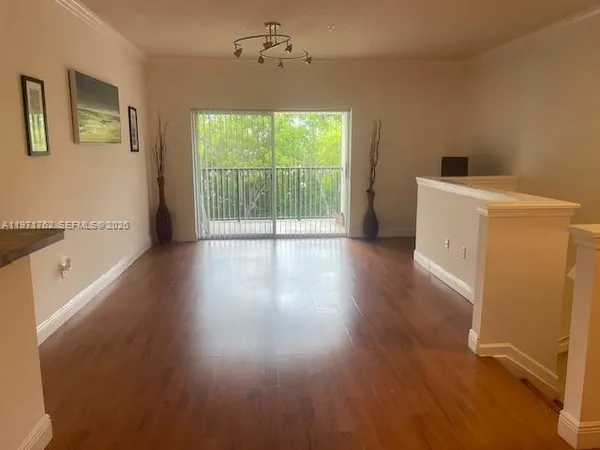 a view of a livingroom with wooden floor and a ceiling fan