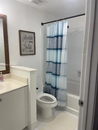 a bathroom with a toilet a sink and shower
