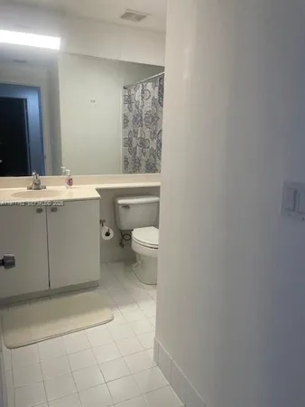 a bathroom with a sink a toilet and mirror