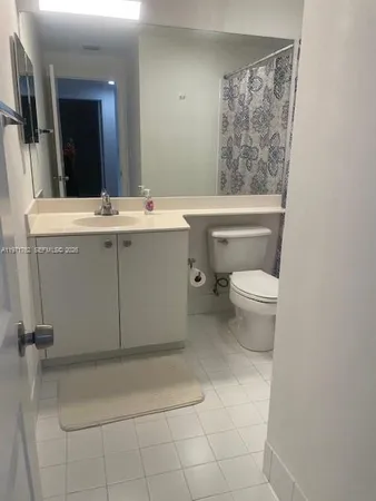 a bathroom with a sink toilet and mirror