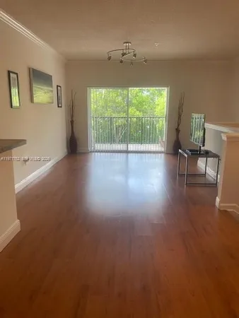 a view of livingroom with furniture wooden floor and windows