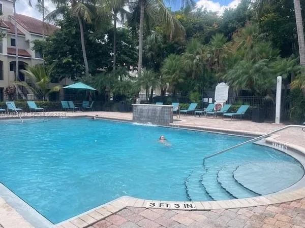 swimming pool view with a seating space