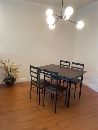 a view of a dining room with furniture and a chandelier