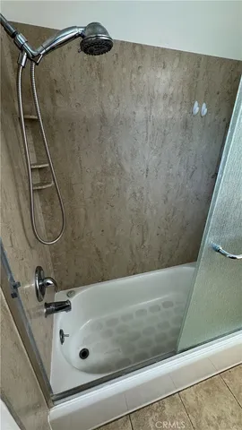 a bathroom with a tub and a shower