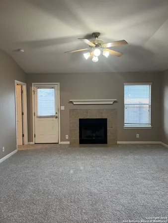 a view of empty room with window and fireplace