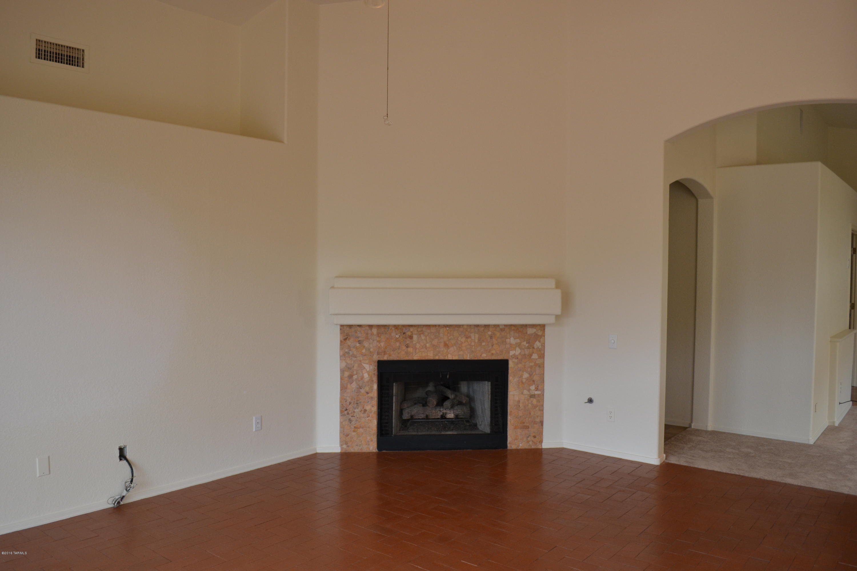 5640 North Cherokee Ridge Road Tucson, AZ 85750 - Photo 7 of 39 a view of an empty room with a fireplace