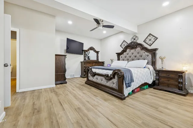 a bedroom with a bed and a television