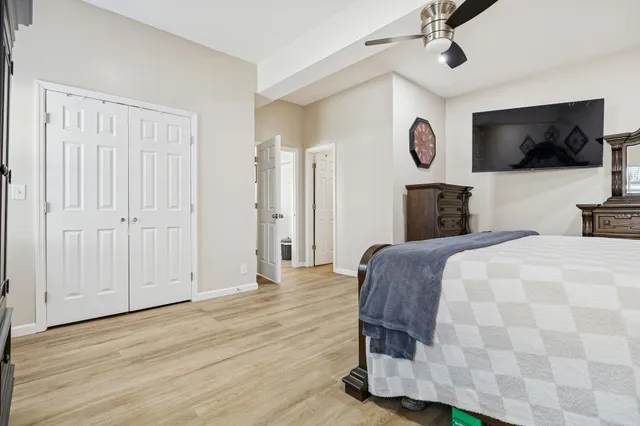 a bedroom with a bed and a flat screen tv