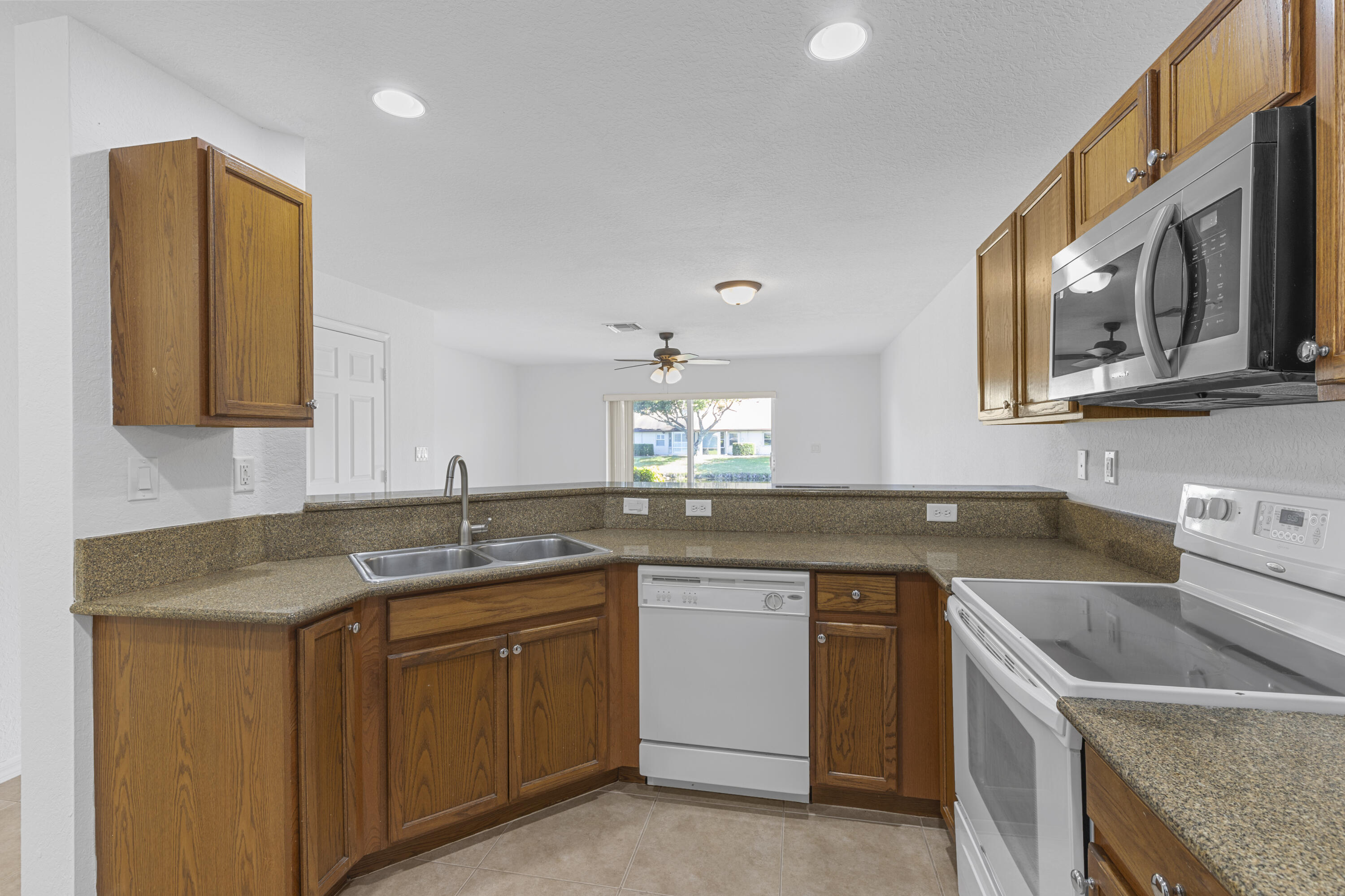 9107 Chambers Street, Unit 9107 Tamarac, FL 33321 - Photo 4 of 30 a kitchen with a sink stove and cabinets