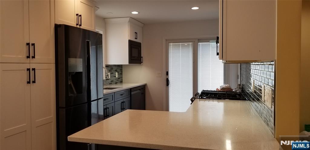 374 East Midland Avenue Paramus, NJ 07652 - Photo 2 of 12 a kitchen with a refrigerator and a stove top oven