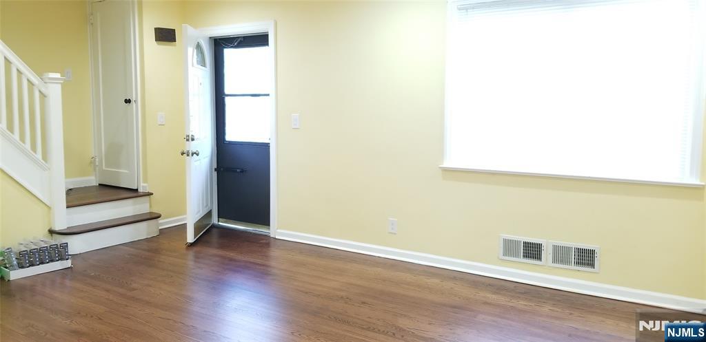 374 East Midland Avenue Paramus, NJ 07652 - Photo 4 of 12 a view of an empty room with wooden floor and a window