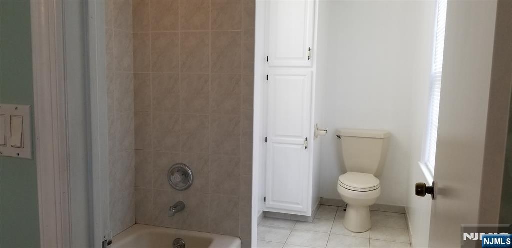 374 East Midland Avenue Paramus, NJ 07652 - Photo 6 of 12 a bathroom with a granite countertop toilet and a shower