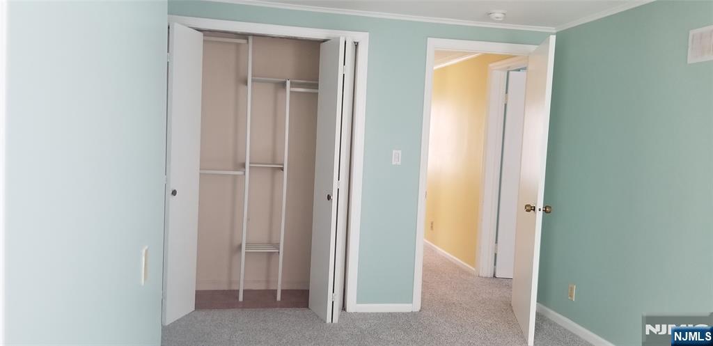 374 East Midland Avenue Paramus, NJ 07652 - Photo 7 of 12 a view of an empty room with closet and mirror