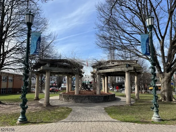 a view of a cafe with table and chairs under an umbrella