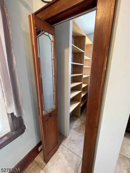 364 Chestnut Street Kearny, NJ 07032 - Photo 9 of 22 a view of closet with wooden floor and stairs