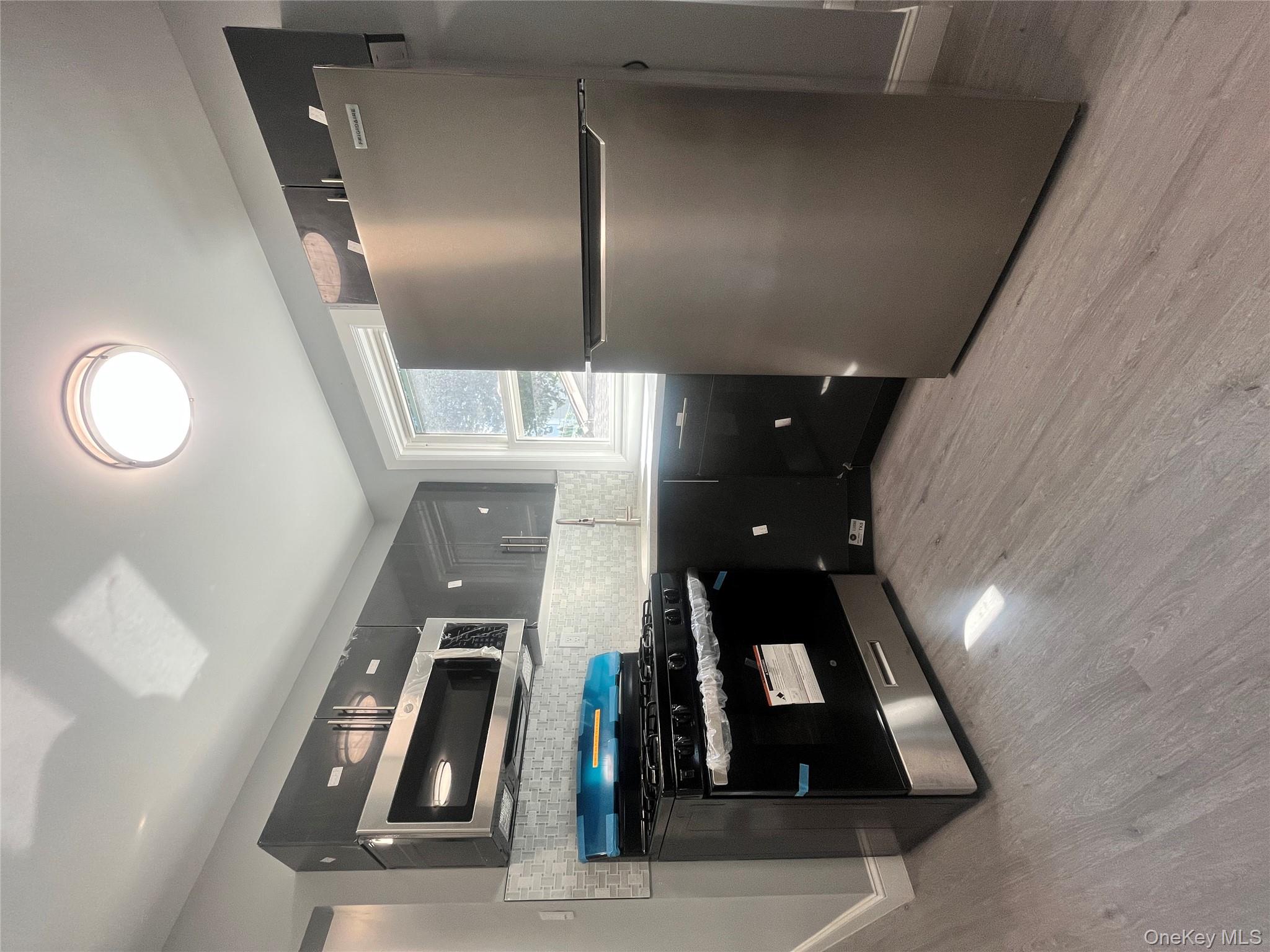 Undisclosed Address Yonkers, NY 10701 - Photo 2 of 10 a kitchen with a refrigerator and a stove