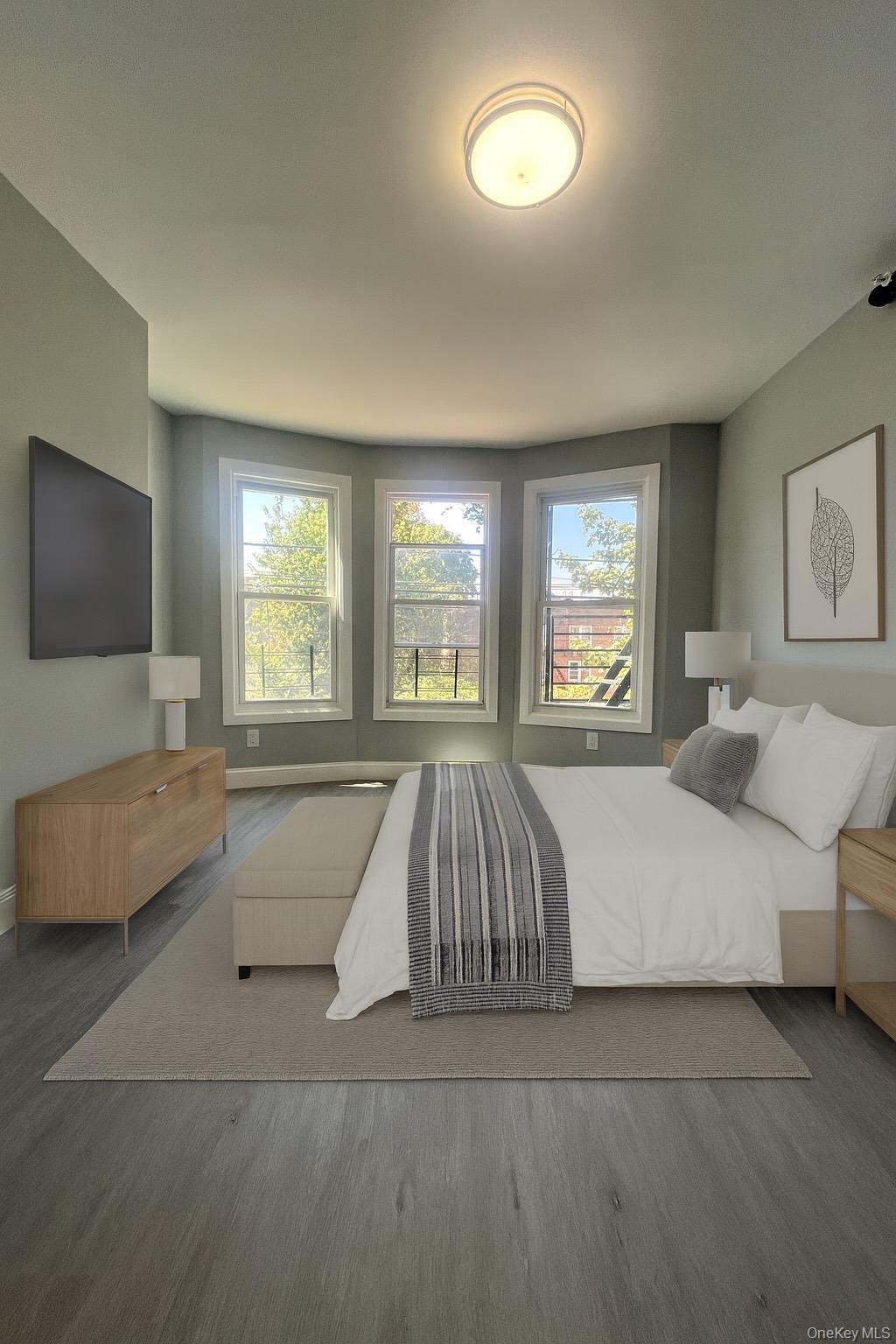 Undisclosed Address Yonkers, NY 10701 - Photo 3 of 10 a spacious bedroom with a large bed and a flat screen tv