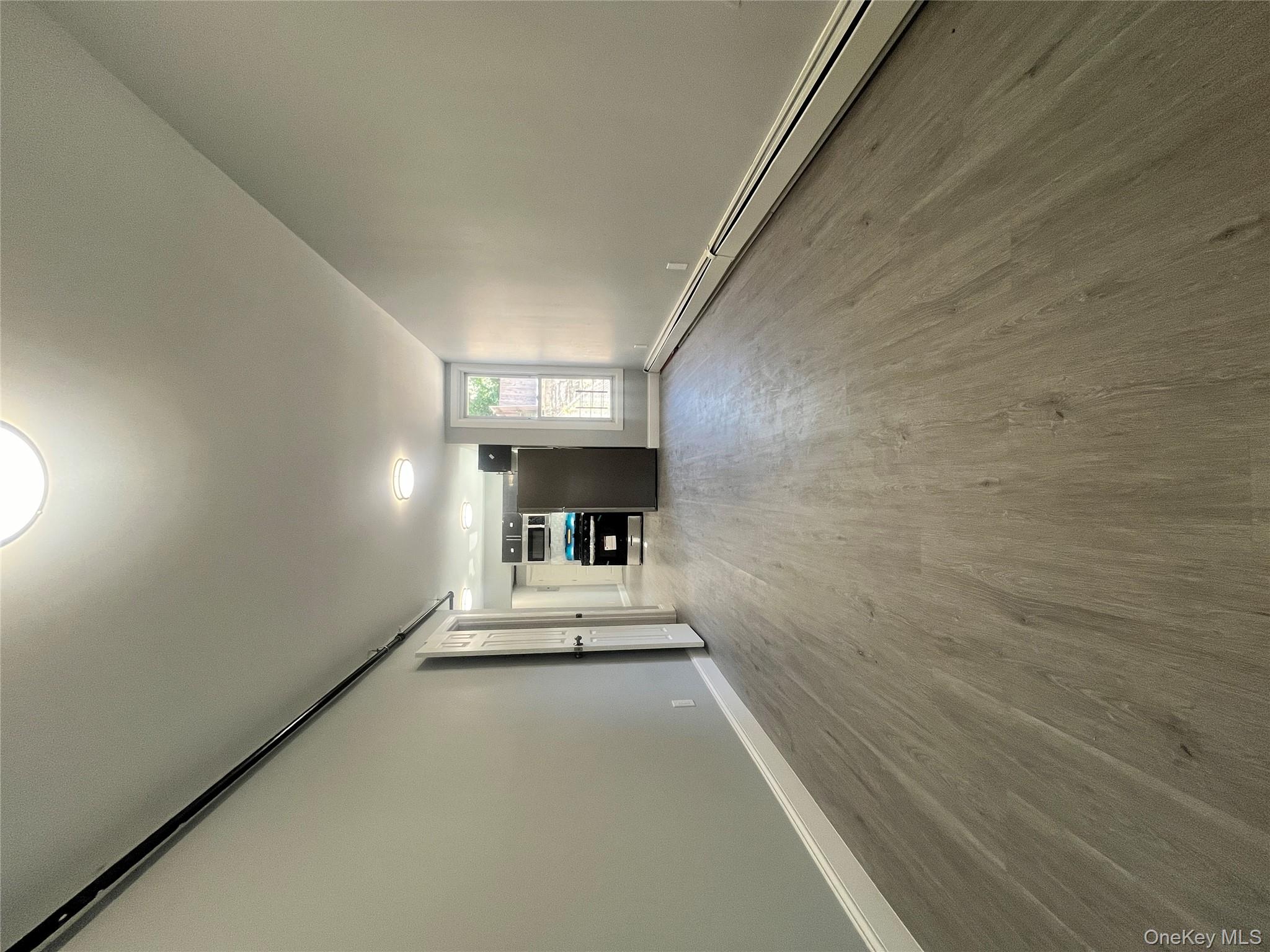 Undisclosed Address Yonkers, NY 10701 - Photo 5 of 10 an empty room with wooden floor and windows