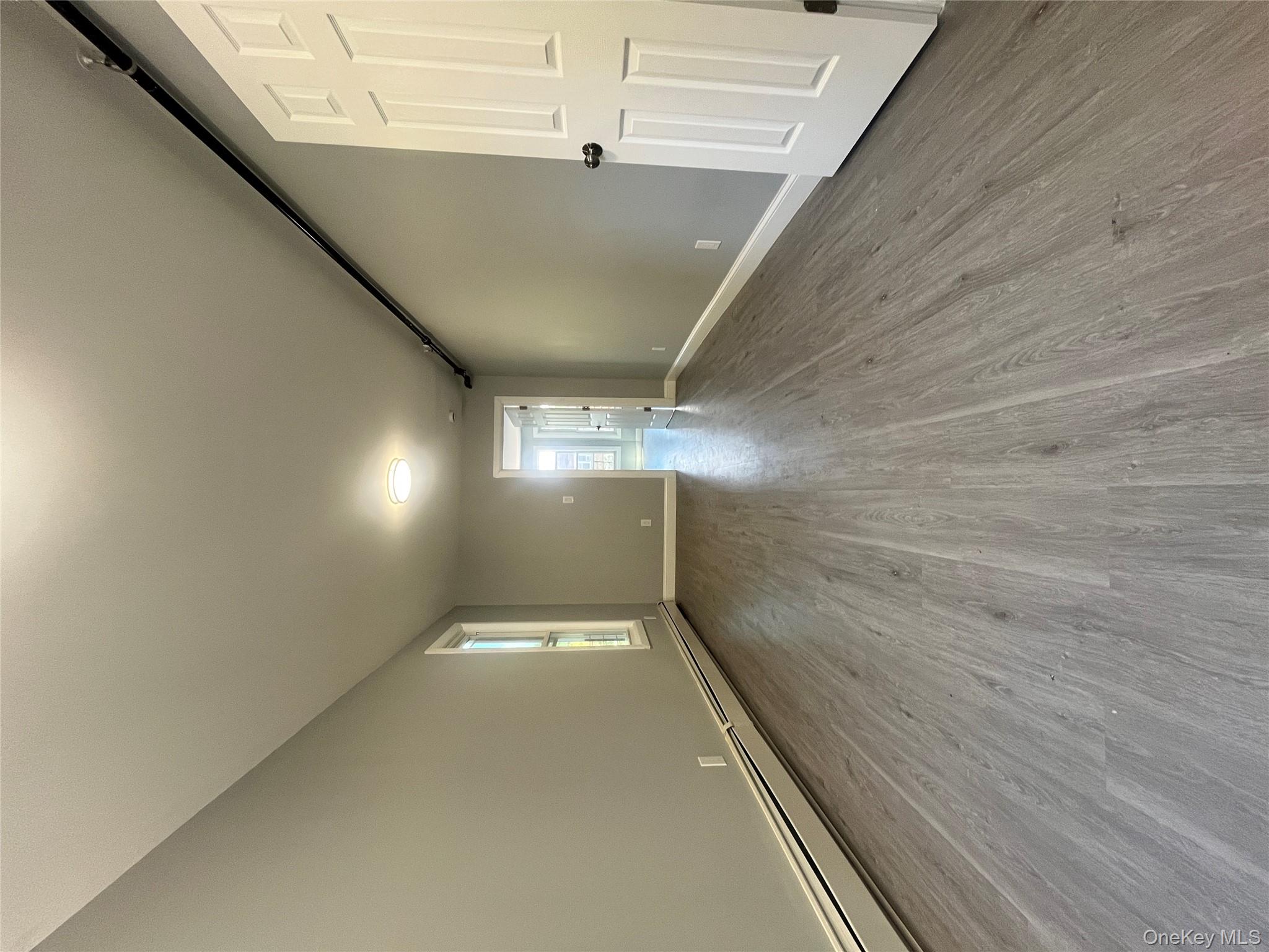 Undisclosed Address Yonkers, NY 10701 - Photo 6 of 10 a view of empty room with wooden floor and entryway