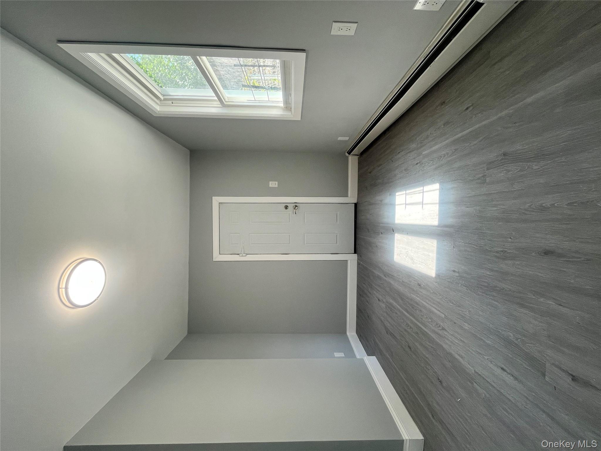 Undisclosed Address Yonkers, NY 10701 - Photo 8 of 10 an empty room with wooden floor and windows