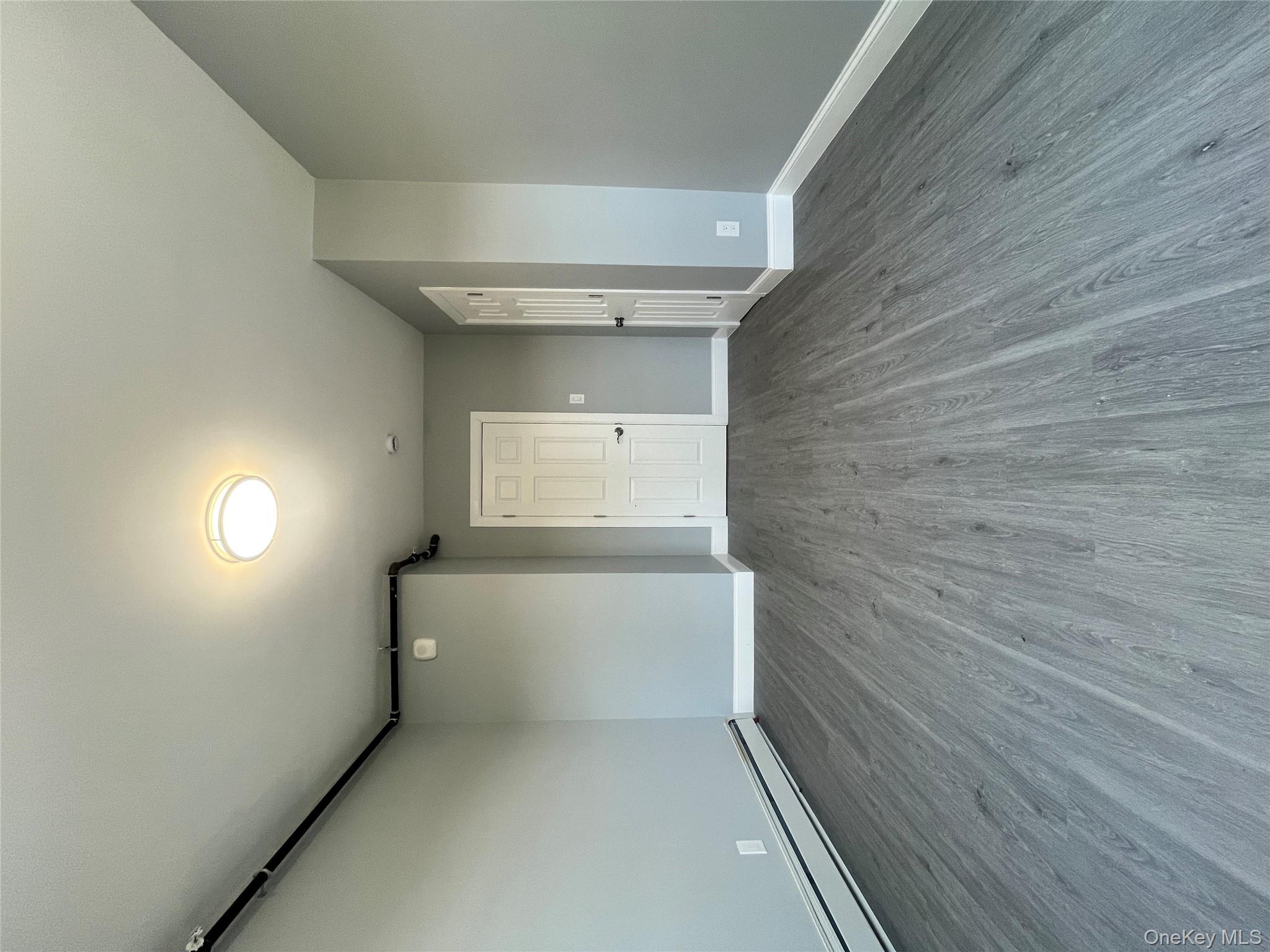 Undisclosed Address Yonkers, NY 10701 - Photo 10 of 10 an empty room with wooden floor and windows