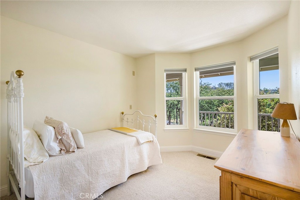 3731 Royal Mountain Road Oroville, CA 95965 - Photo 23 of 67 a spacious bedroom with a bed and a large window
