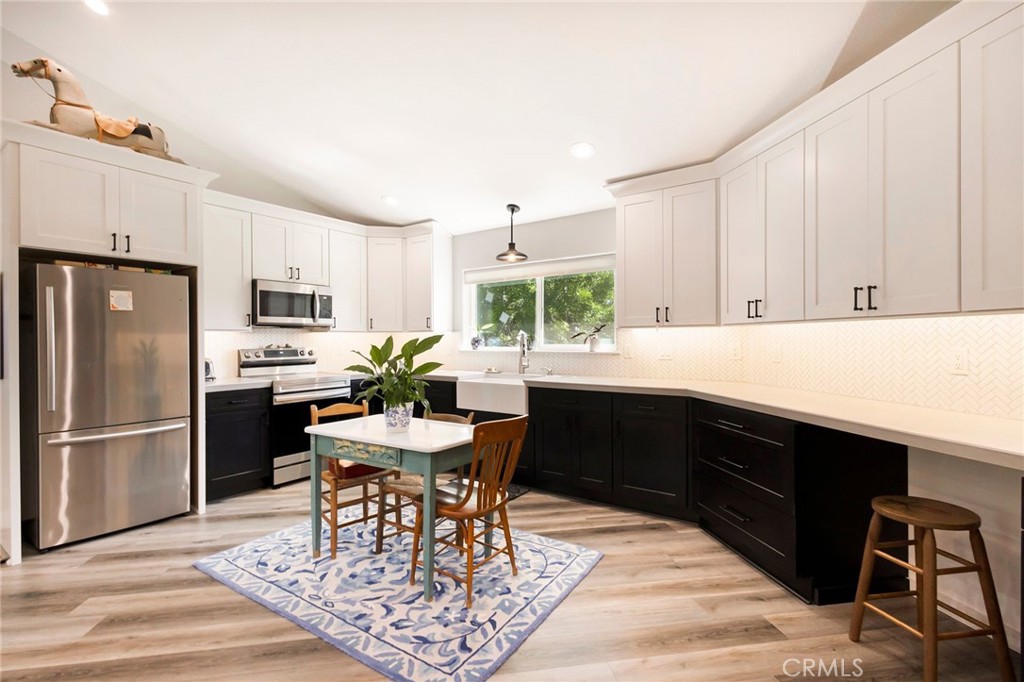 3731 Royal Mountain Road Oroville, CA 95965 - Photo 48 of 67 a kitchen with stainless steel appliances granite countertop a sink dishwasher a stove a refrigerator with a dining table and chairs