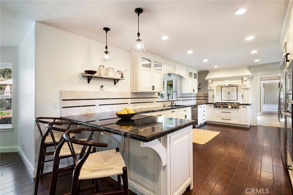 3731 Royal Mountain Road Oroville, CA 95965 - Photo 5 of 67 a kitchen with stainless steel appliances kitchen island granite countertop a table chairs sink and cabinets