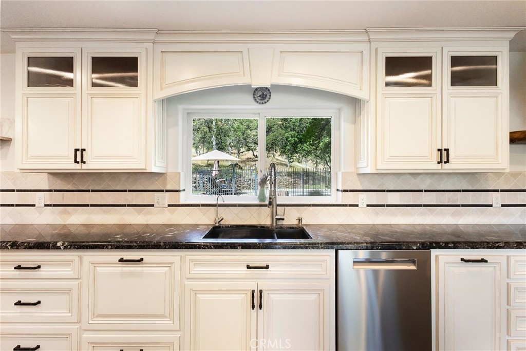 3731 Royal Mountain Road Oroville, CA 95965 - Photo 7 of 67 a kitchen with granite countertop white cabinets and a window