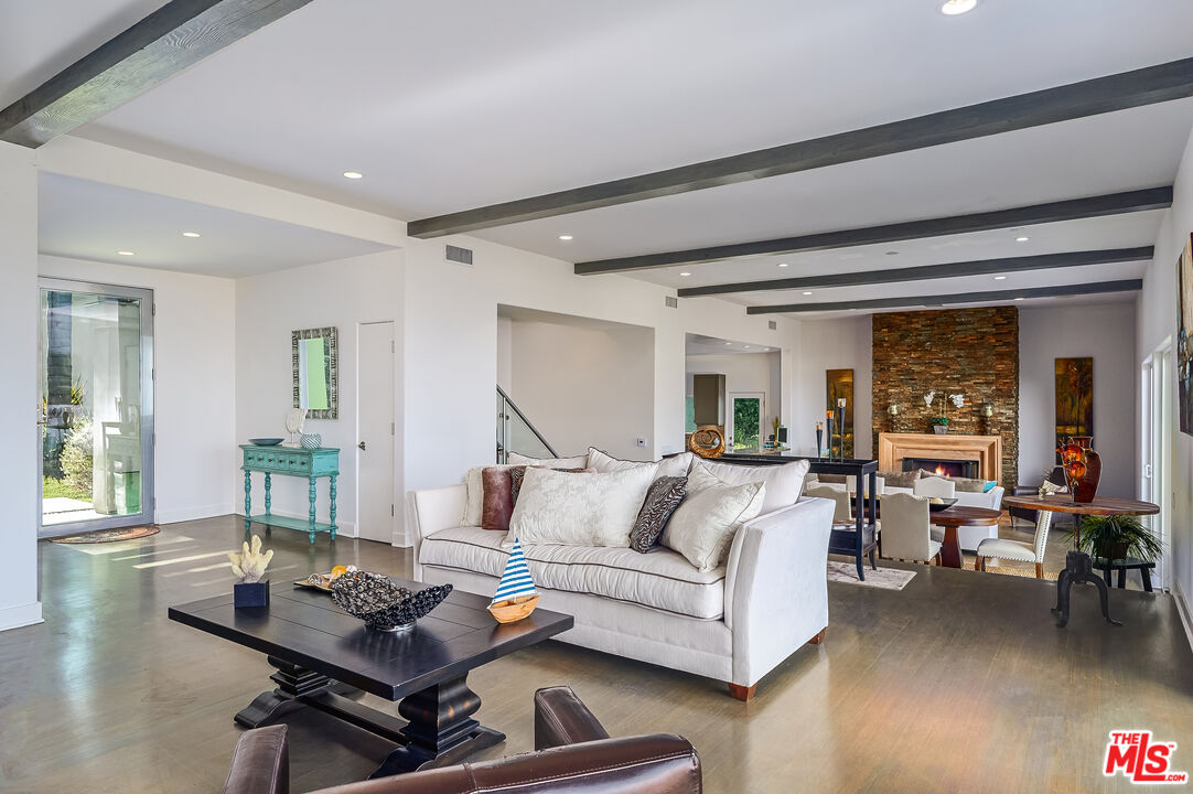 28907 Wight Road Malibu, CA 90265 - Photo 12 of 54 a living room with furniture and a wooden floor