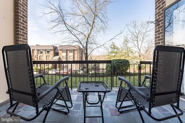 a view of a chairs and table in the balcony