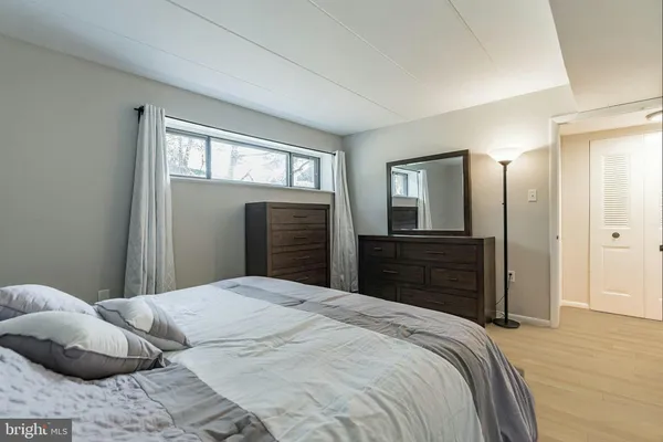 a bedroom with a bed and a dresser