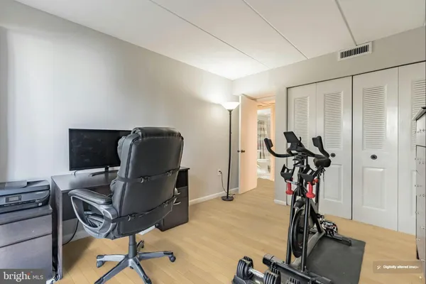 a view of a workspace with furniture and gym equipment